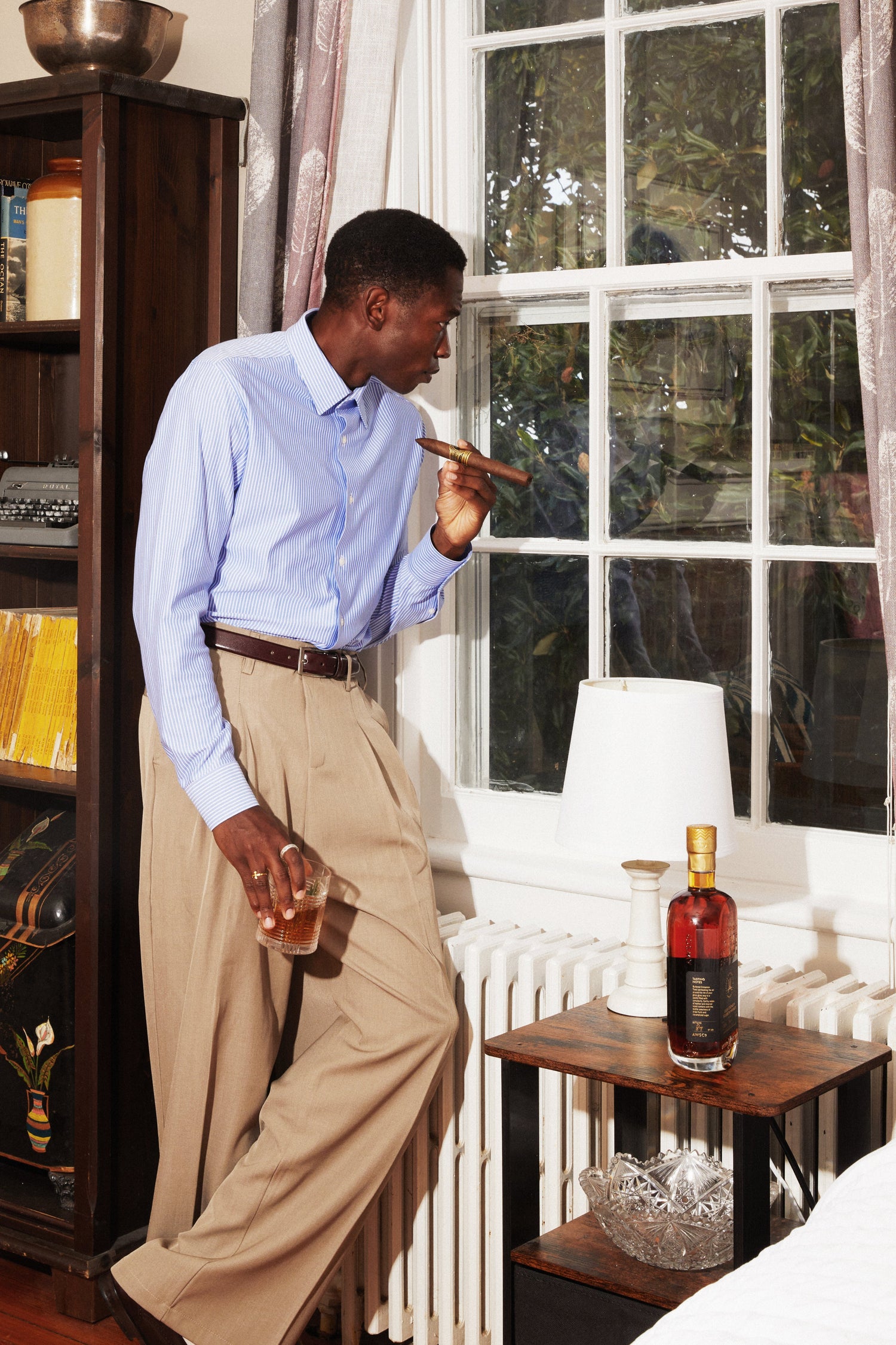 Man Looking Out Window with Cigar